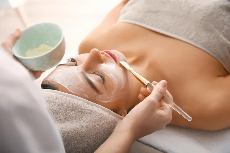 Cream applied to woman's face with brish