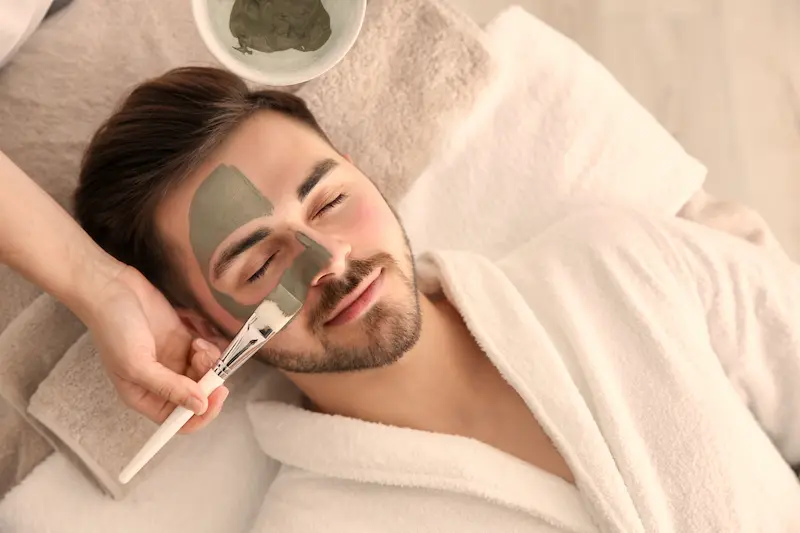 Man receiving a facial treatment