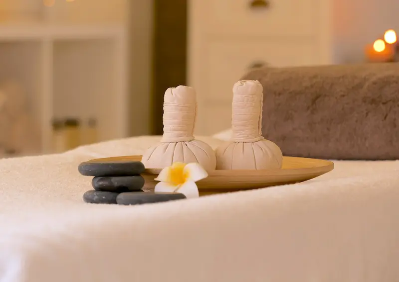 Candles and Stones on a Massage Table