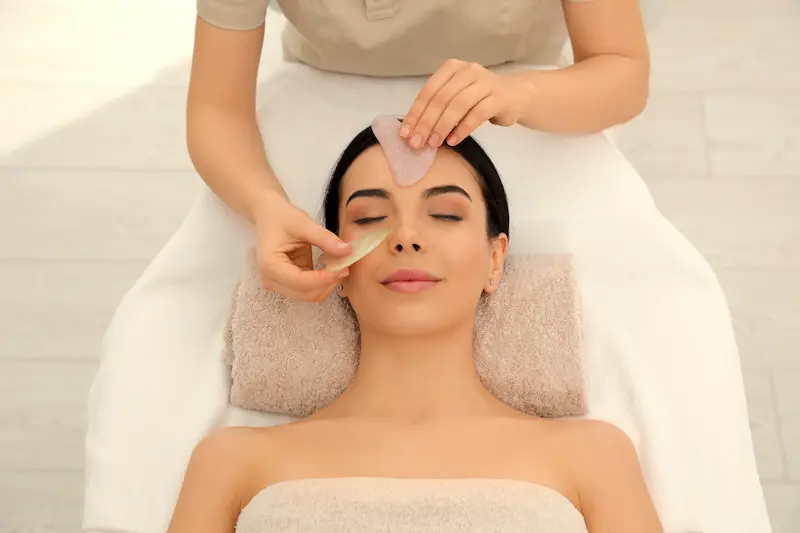 Woman receiving a stone facial