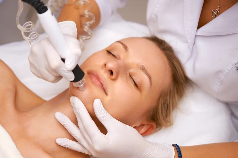 Medical device being used on woman's face