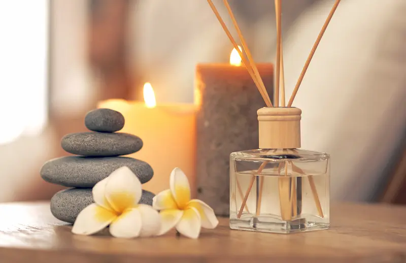 Scented oils, lit candles and stacked stones