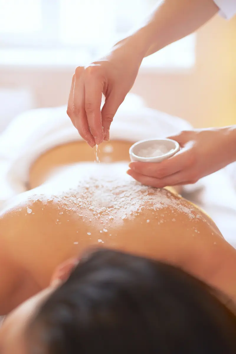 Salt Massage on woman's back