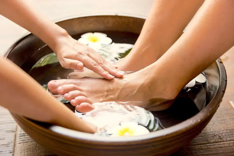 Massaging feet submerged in water
