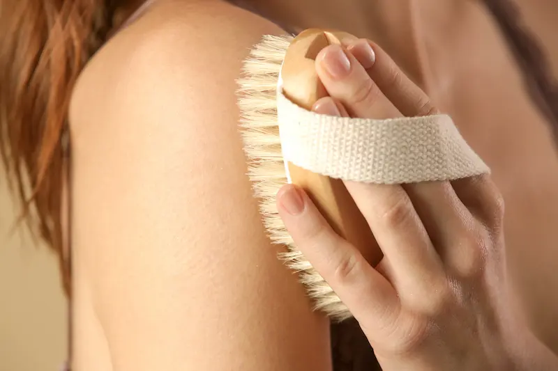 Scrub brush against soft skin